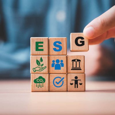 Businessman assemble ESG wording on wooden cube block for sustainable organization development and corporation of Environment Social Governance concept.